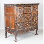 An 18th century and later oak cupboard, fitted with an arrangement of drawers and doors, all with