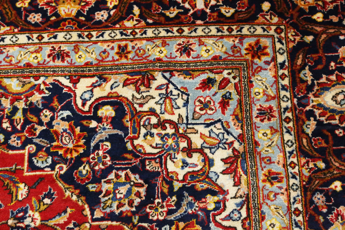 A Kashan carpet, Central Persia, modern, the red field with a shaped medallion, within a blue - Image 4 of 9