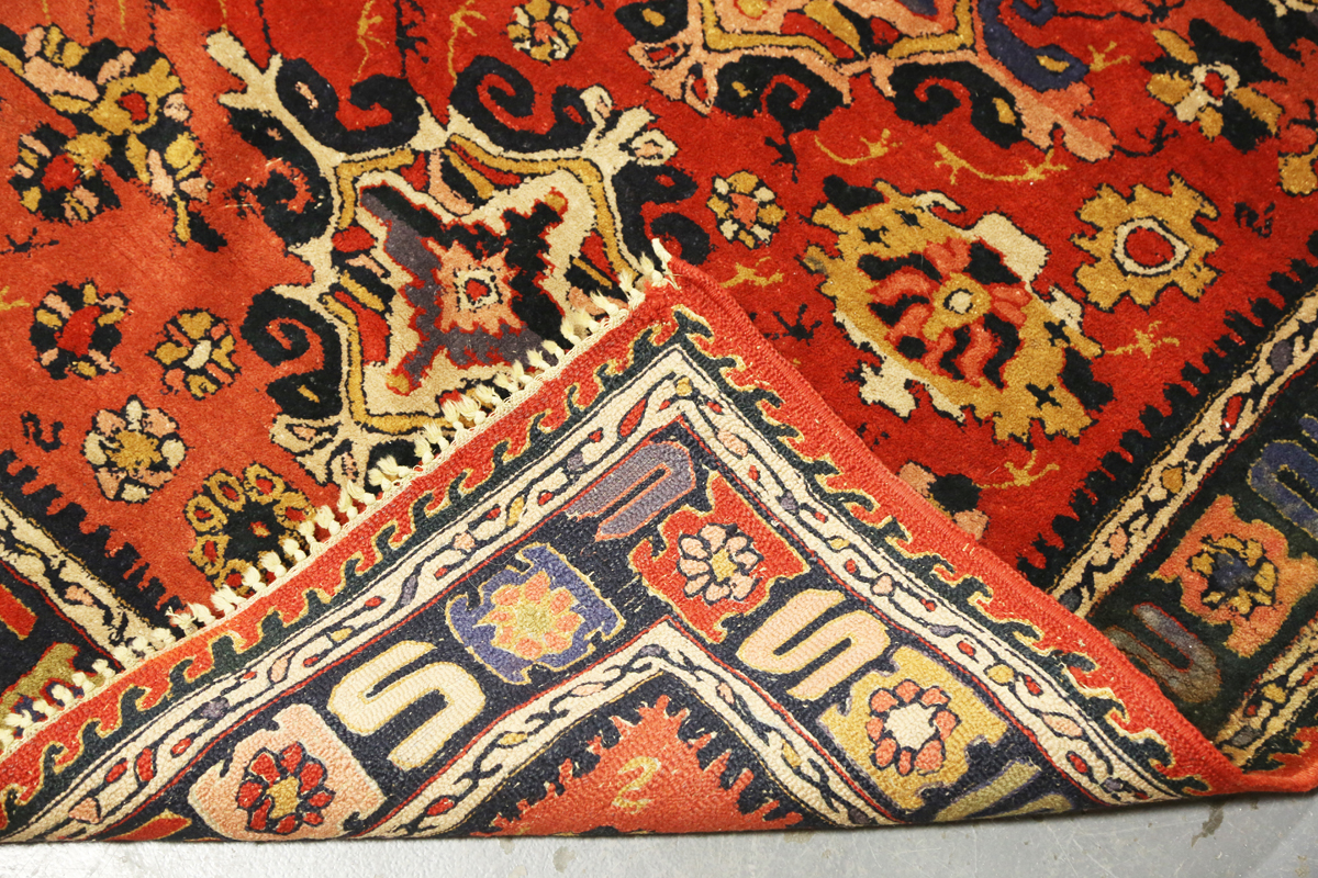 A Persian style rug, 20th century, the deep terracotta field with a column of palmettes, within a - Image 2 of 12