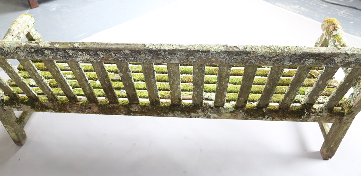 A 20th century teak garden bench, covered in green lichen, height 81cm, width 182cm, depth 70cm. - Image 3 of 11