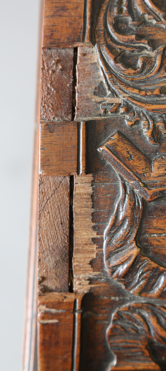 An 18th century French walnut domed trunk, finely carved with coats of arms, initials and further - Image 10 of 14