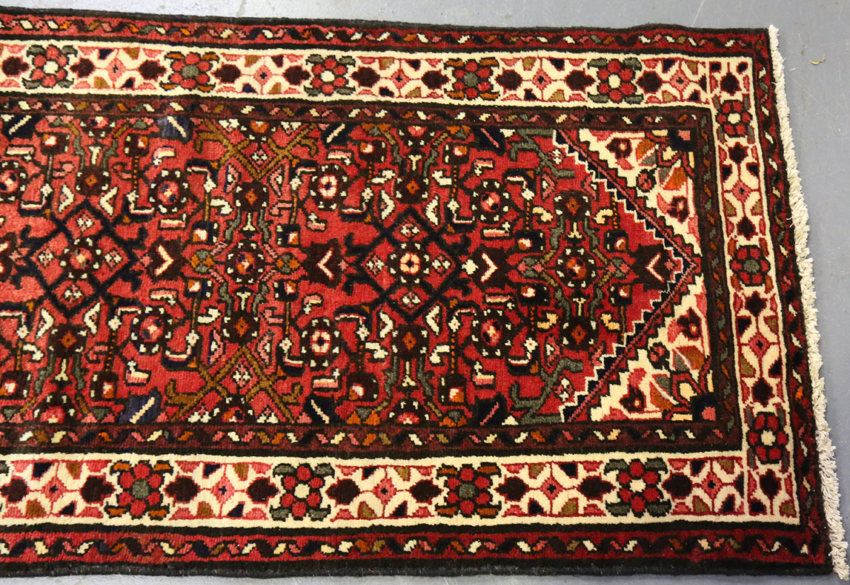 A Malayer runner, North-west Persia, mid/late 20th century, the red field with an overall floral - Image 2 of 8