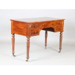 An early Victorian mahogany dressing table, fitted with five drawers, on turned tapering legs,