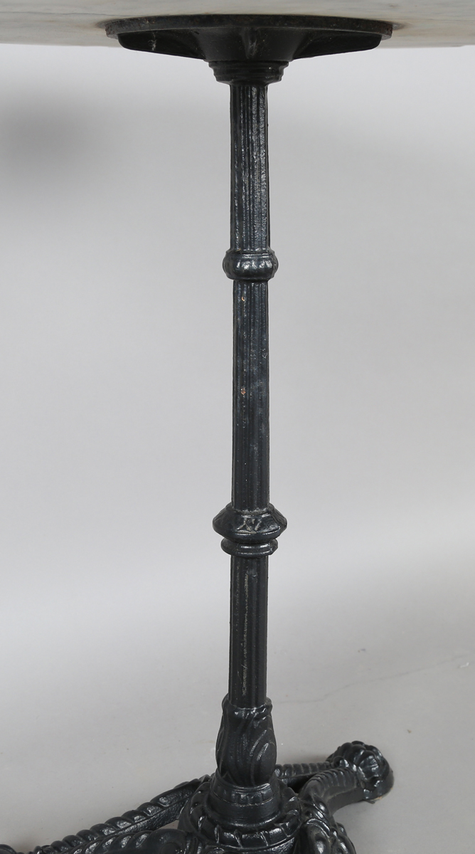 A 20th century black painted cast iron and marble-topped table, height 74cm, diameter 60cm.Buyer’s - Image 2 of 4