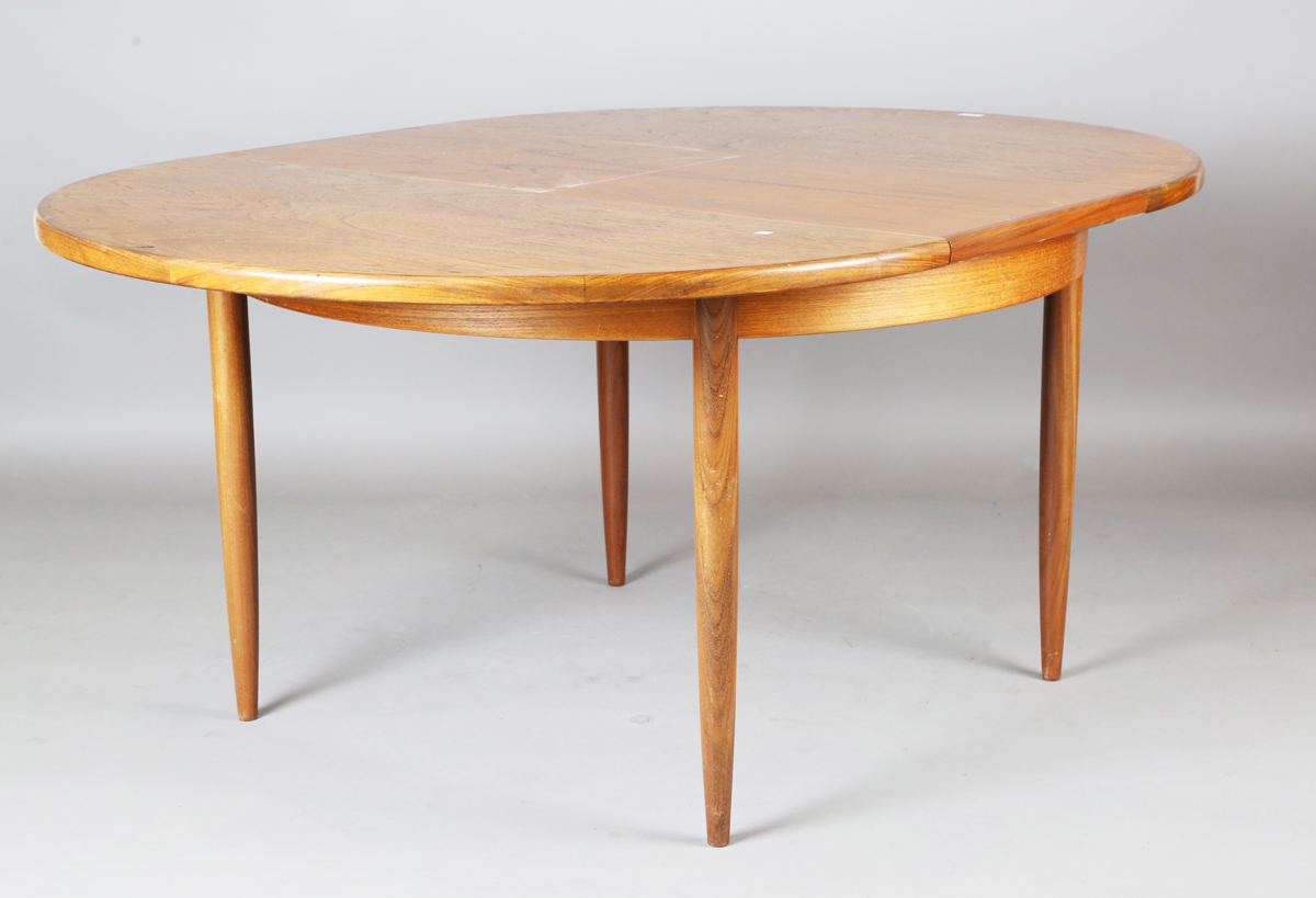A mid-20th century G-plan teak extending dining table, the top with single extra leaf, height