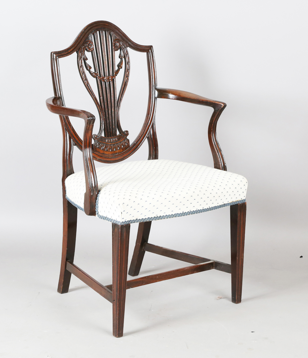 A George III mahogany shield back elbow chair, the seat covered in a patterned damask, height