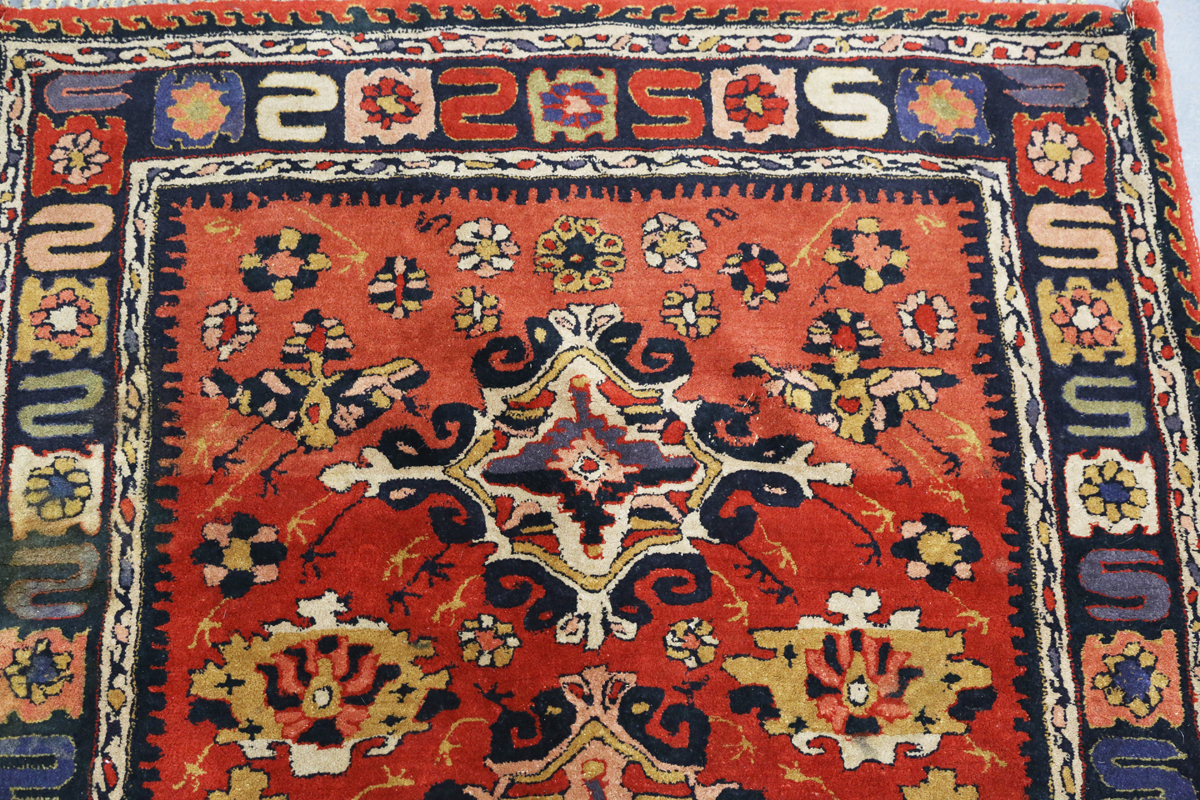 A Persian style rug, 20th century, the deep terracotta field with a column of palmettes, within a - Image 12 of 12