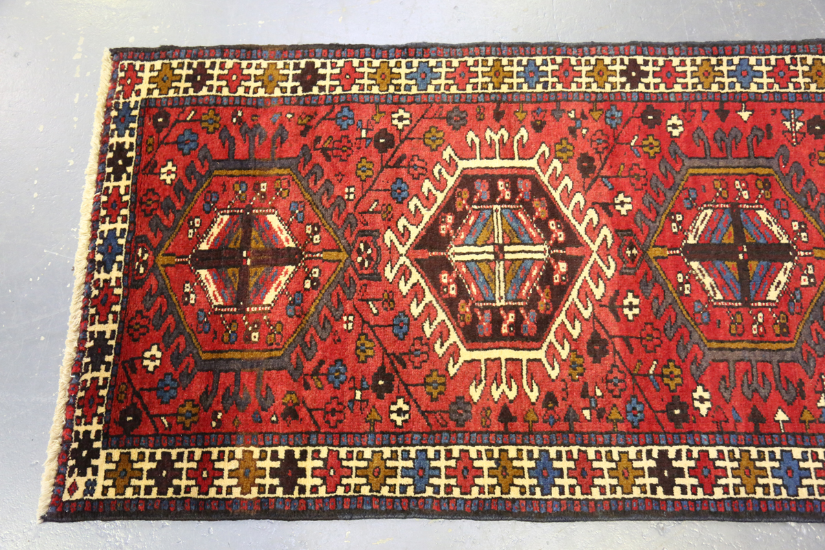 A Heriz runner, North-west Persia, mid-20th century, the red field with a column of hooked - Image 7 of 7