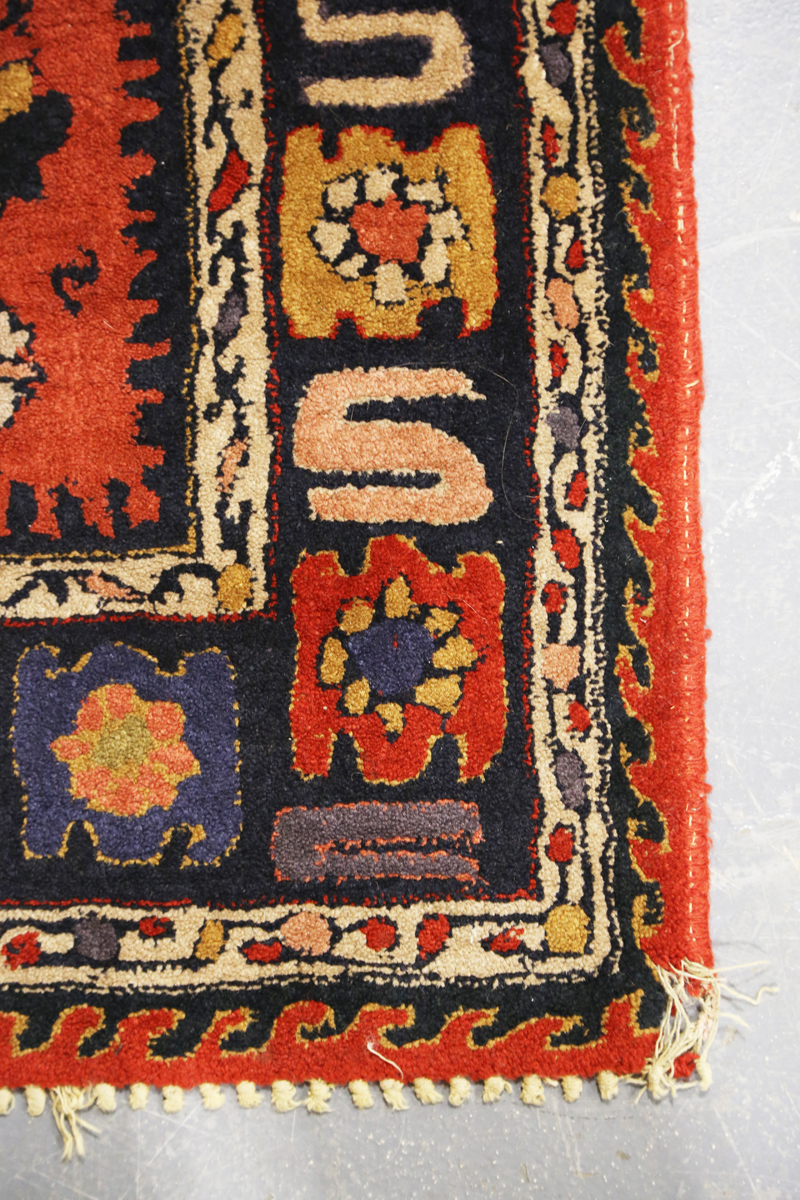 A Persian style rug, 20th century, the deep terracotta field with a column of palmettes, within a - Image 7 of 12