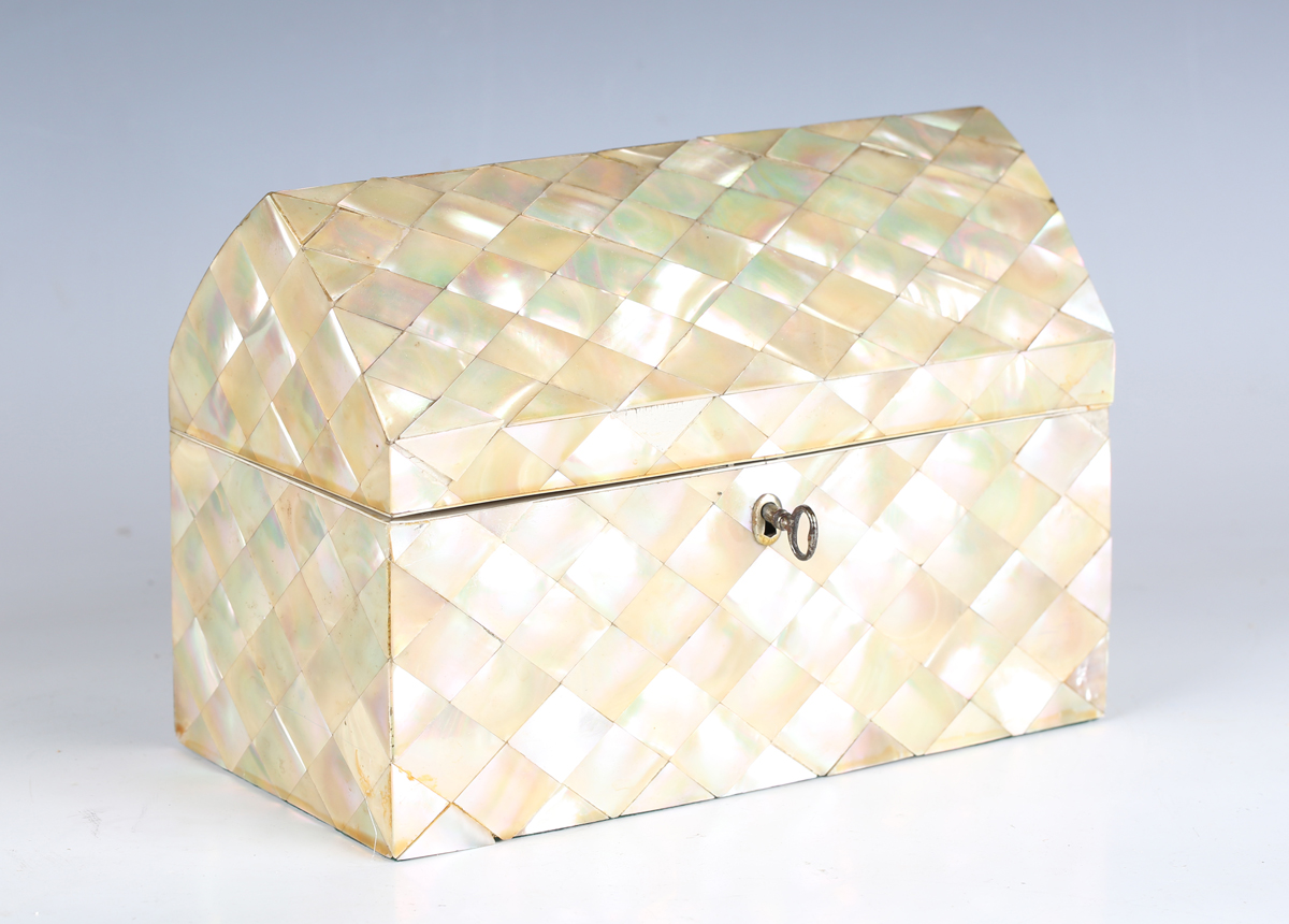 A late 19th century mother-of-pearl veneered stationery box, the arched lid revealing a later fitted