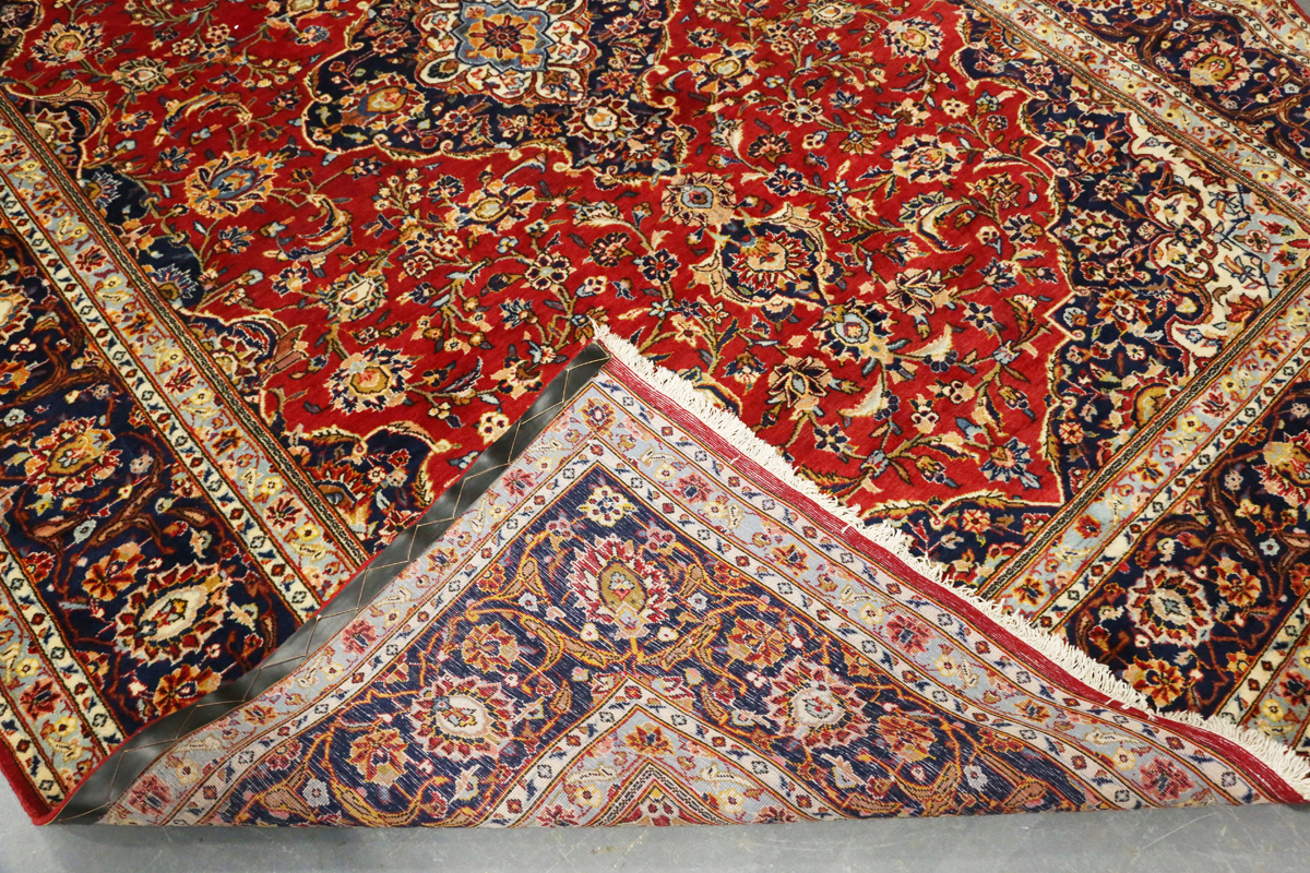 A Kashan carpet, Central Persia, modern, the red field with a shaped medallion, within a blue - Image 2 of 9