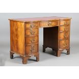 A late 20th century reproduction mahogany twin pedestal desk, the top inset with red leather, height