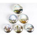 A group of six Victorian glass paperweights, all with printed scenes of Royal residences to the