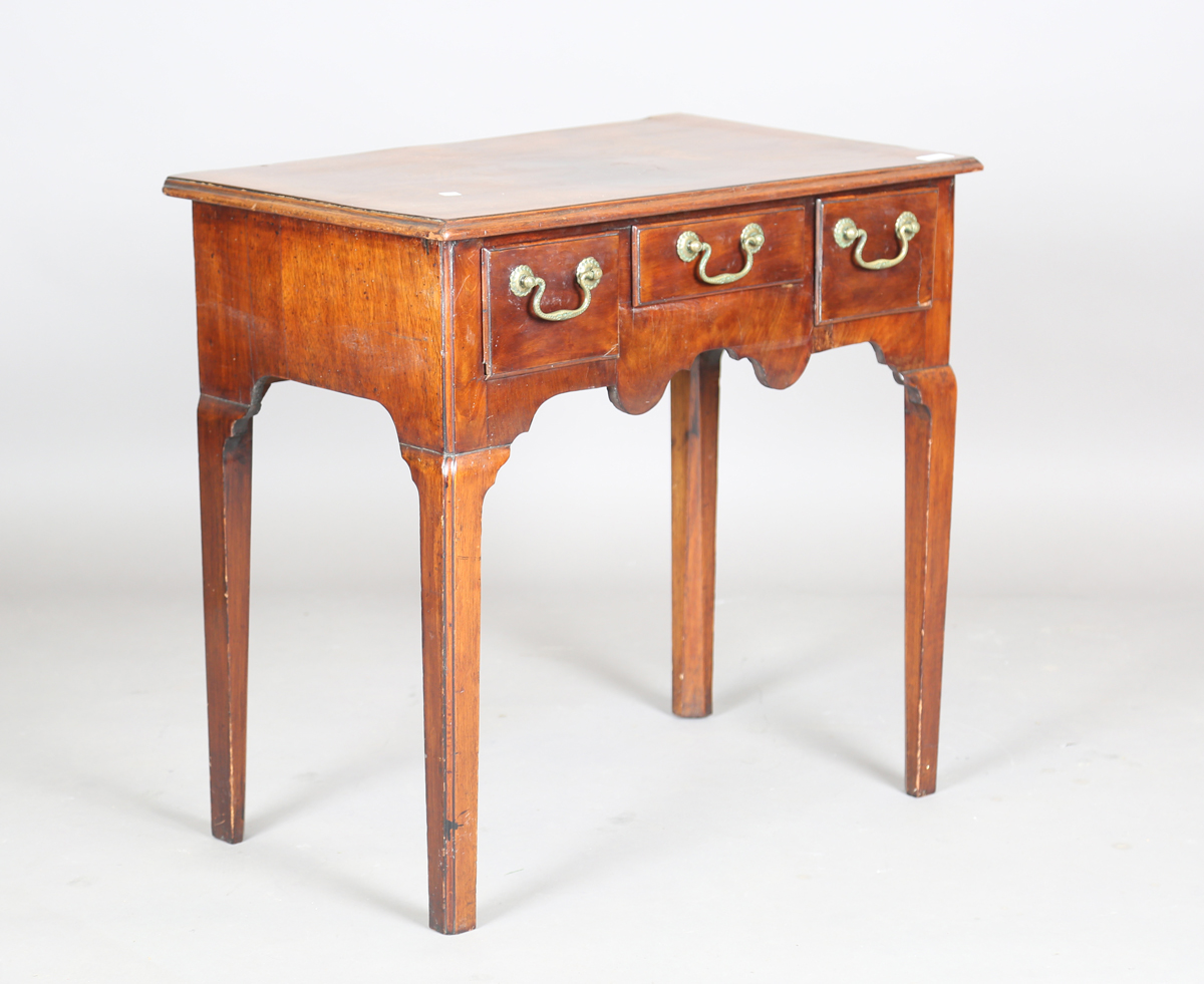 A George III mahogany side table, fitted with three oak-lined drawers, height 71cm, width 74cm,