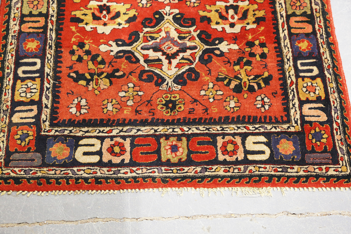A Persian style rug, 20th century, the deep terracotta field with a column of palmettes, within a - Image 9 of 12
