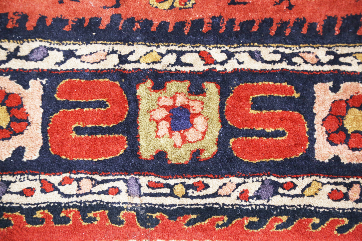 A Persian style rug, 20th century, the deep terracotta field with a column of palmettes, within a - Image 8 of 12