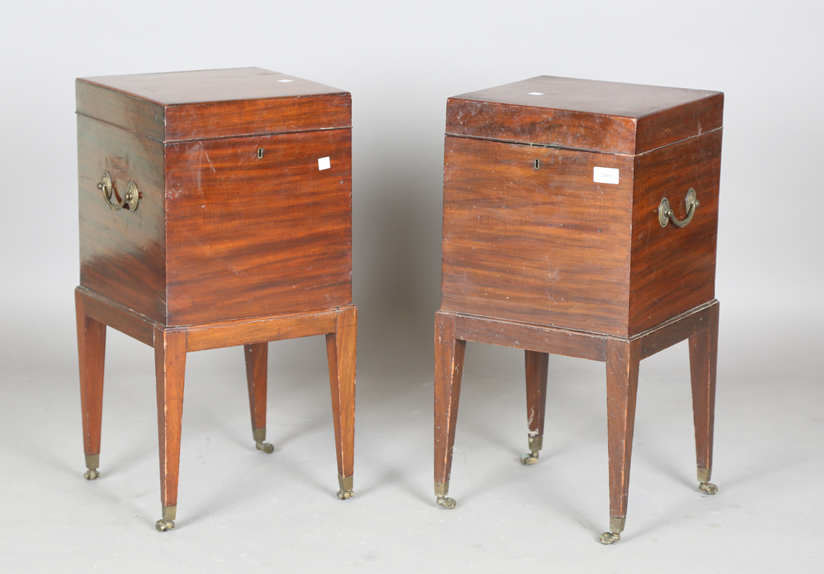 A pair of George III style mahogany wine coolers, each fitted with two brass swing handles, on