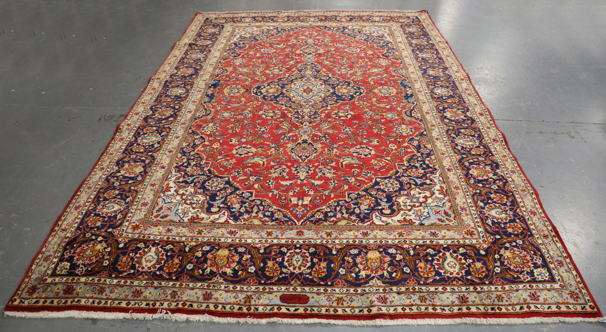 A Kashan carpet, Central Persia, modern, the red field with a shaped medallion, within a blue