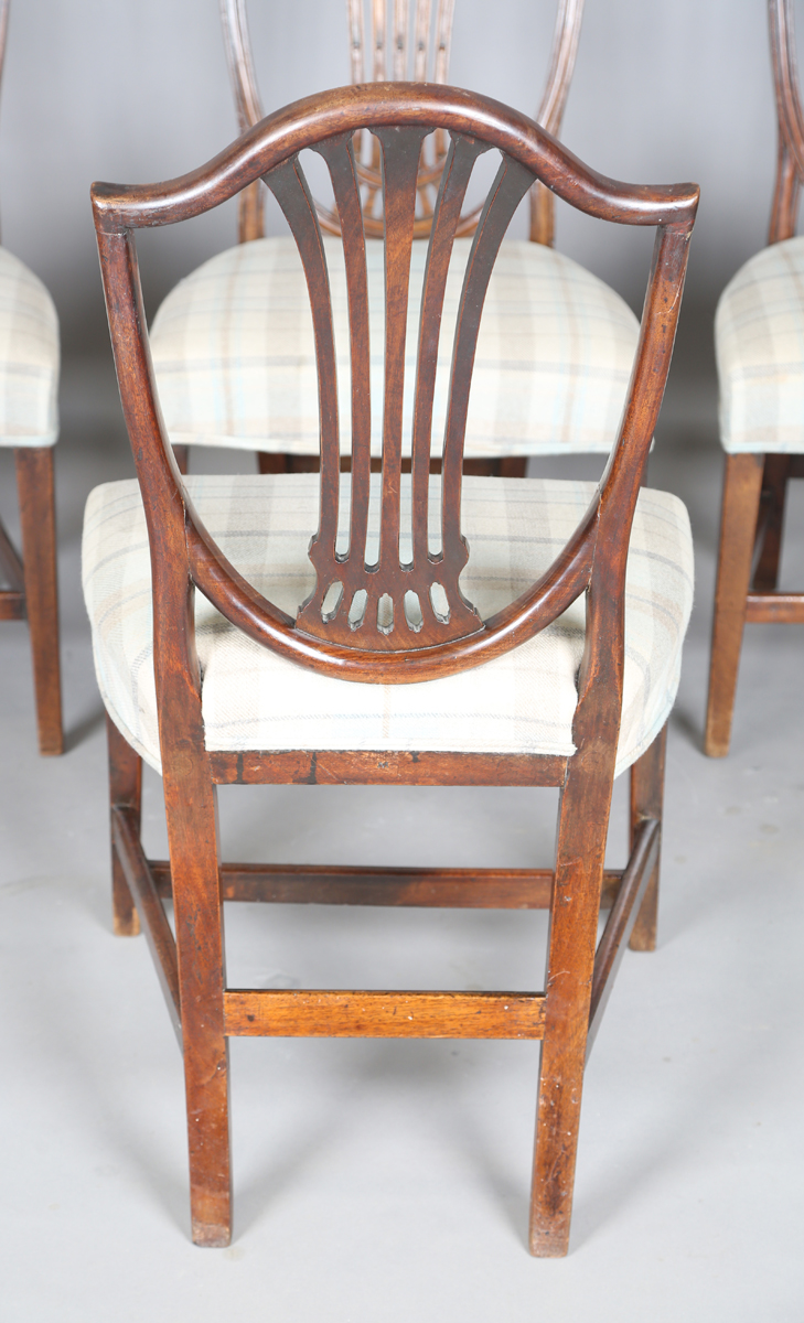 A set of four George III mahogany dining chairs with pierced splat backs and overstuffed seats, - Image 6 of 12