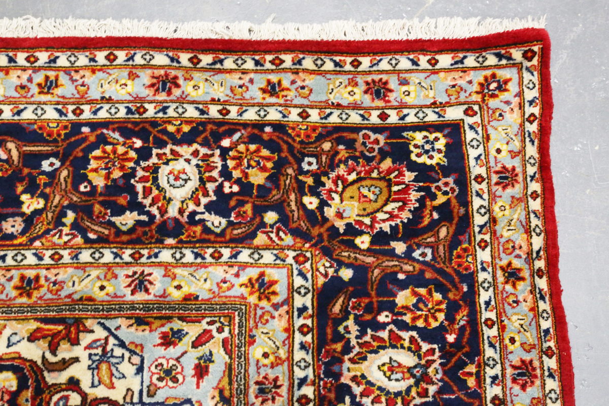 A Kashan carpet, Central Persia, modern, the red field with a shaped medallion, within a blue - Image 7 of 9