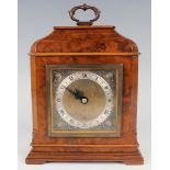 A 20th century walnut cased mantel timepiece, the square brass dial detailed 'An Elliott Clock', the