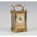 An early 20th century French gilt brass carriage timepiece with eight day movement, the cream