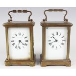 Two early 20th century brass cased carriage timepieces, each corniche case with swing handle and