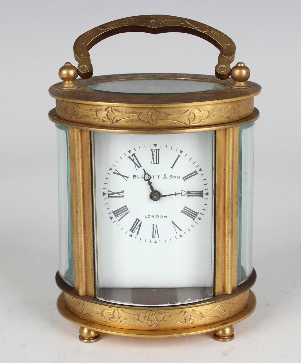 A 20th century Chinese brass oval cased carriage timepiece, the enamelled dial with black Roman hour
