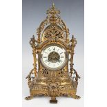 A late 19th century French gilt brass cased mantel clock with eight day movement striking on a gong,