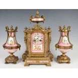 A late 19th century French gilt metal and porcelain clock garniture, the mantel clock with eight day