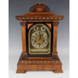 A late 19th century walnut cased mantel clock with Junghans eight day movement chiming and