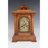 A late 19th century German walnut cased mantel clock with eight day movement chiming on gongs, the