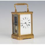 A late 19th century French gilt brass carriage clock with eight day movement striking hours, half