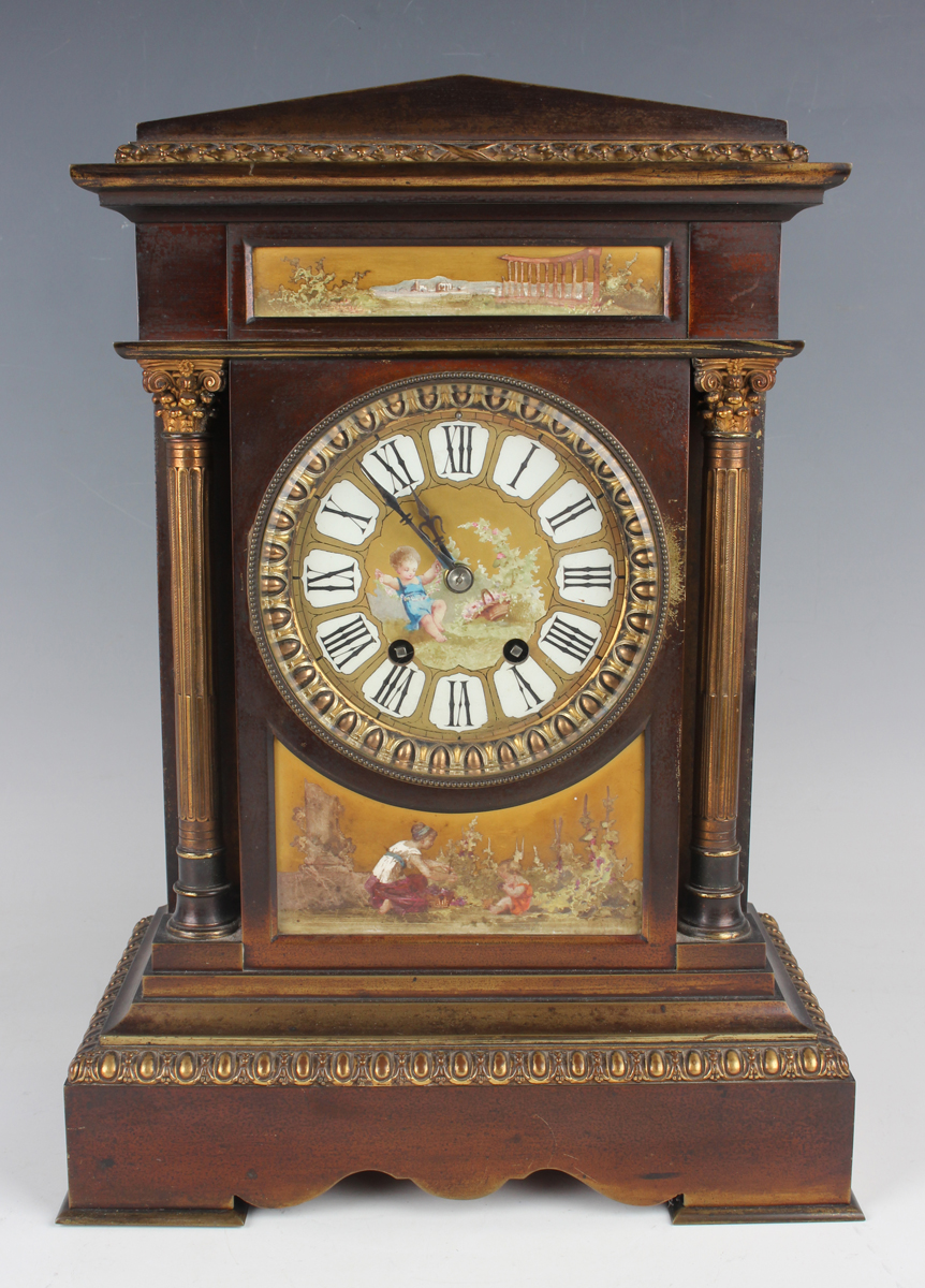 A late 19th century French brown patinated brass and porcelain mounted mantel clock with eight day