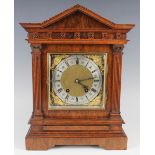 An early 20th century walnut mantel clock with eight day Lenzkirch movement striking on gongs, the