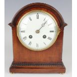 An Edwardian mahogany mantel clock with French eight day movement striking on a gong, the circular