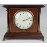 An Edwardian mahogany cased mantel timepiece with eight day movement, the circular enamelled dial
