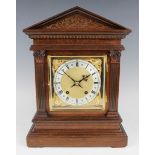 An early 20th century mahogany mantel clock with eight day movement striking on a gong, the