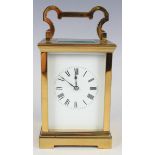 A 20th century French lacquered brass carriage clock with eight day movement striking hours and half