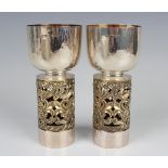 A pair of Elizabeth II Aurum silver and parcel gilt Hereford Cathedral goblets, commemorating the