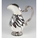 A Continental .925 silver jug of wrythen baluster form with gadrooned and scroll handle, on an