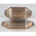A pair of Edwardian silver tapering canted corner rectangular dishes, each with beaded rim