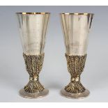 A pair of Elizabeth II Aurum silver and parcel gilt Chichester Cathedral goblets, commemorating
