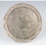 A Victorian silver circular card salver, engraved with flowers and scrolling leaves within a pierced