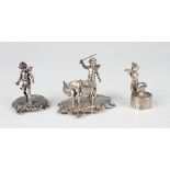 A late Victorian silver model of a cherub standing beside a donkey carrying two baskets, on an