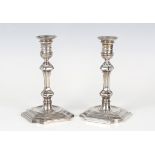 A pair of Edwardian silver hexagonal baluster candlesticks, each urn shaped sconce with detachable