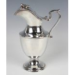 A Continental .925 silver ewer of baluster form, the hinged lid surmounted by a frog flanked by a