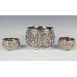 A late 19th century Burmese silver circular bowl, the body decorated in relief with figures and