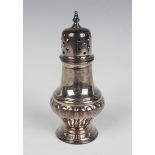 An Elizabeth II silver sugar caster of half-reeded baluster form with pierced domed cover, on a