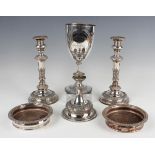 A group of plated items, comprising a pair of baluster candlesticks with floral and foliate